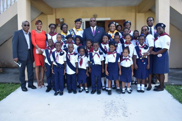 Photo: Prime Minister Harris and his Cabinet colleagues Hon. Ian Patches Liburd and Hon. Eugene Hamilton pose with Seventh-Day Adventist Pathfinders.  